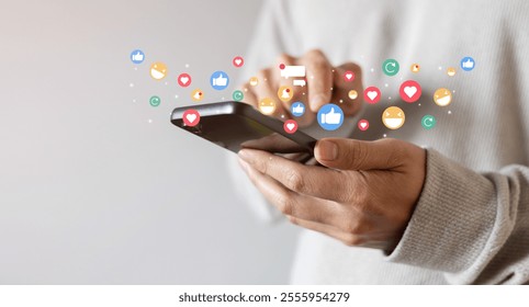 adult man hand hold smartphone and use social media network application to check new feedback or interactive with people or friend by reply chat or send emoticon for  react feeling and moment concept