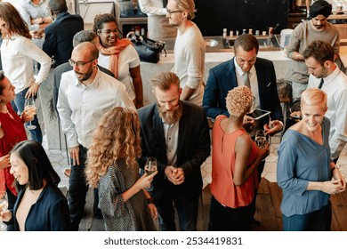 Diverse group of people at social event, mingling and chatting. Diverse crowd enjoy drinks and conversation in lively social gathering party. Social event with diverse group of people mingling