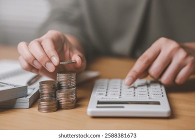 financial planning for retirement, savings and investment saving money. A person is counting money on a table. The person is holding a calculator and has a pile of coins on the table.